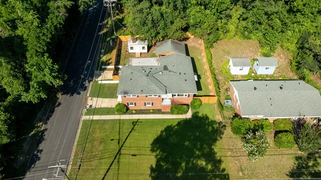 an aerial view of a house with a yard basket ball court and outdoor seating