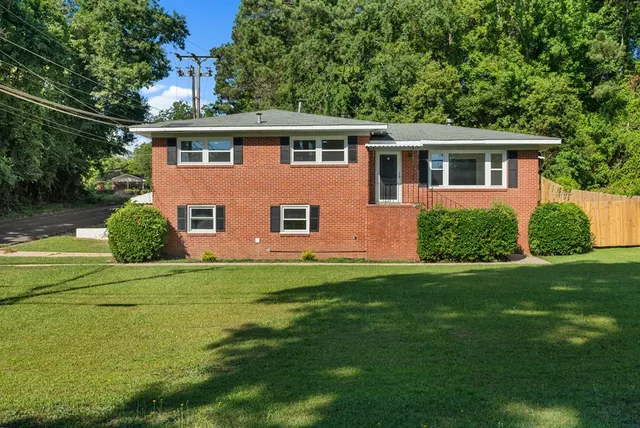 a front view of a house with a garden