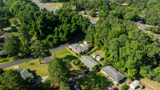 an aerial view of a house with a yard