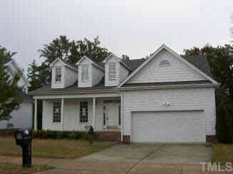 7916 Mill Run Raleigh, NC 27612 - Photo 1 of 1 a front view of a house with a yard and garage