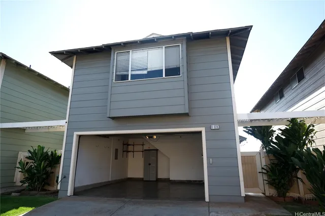a front view of a house with plants