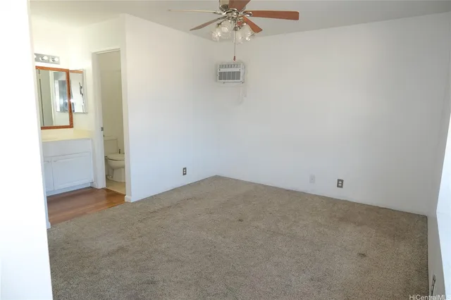 an empty room with a ceiling fan and a window