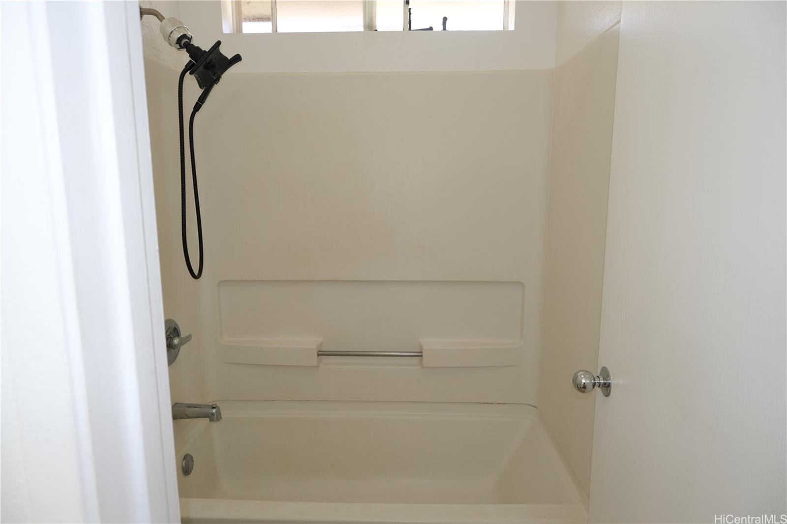 91-1020 Hoomaka Street, Unit 88 Ewa Beach, HI 96706 - Photo 10 of 22 a bathroom with a glass shower door