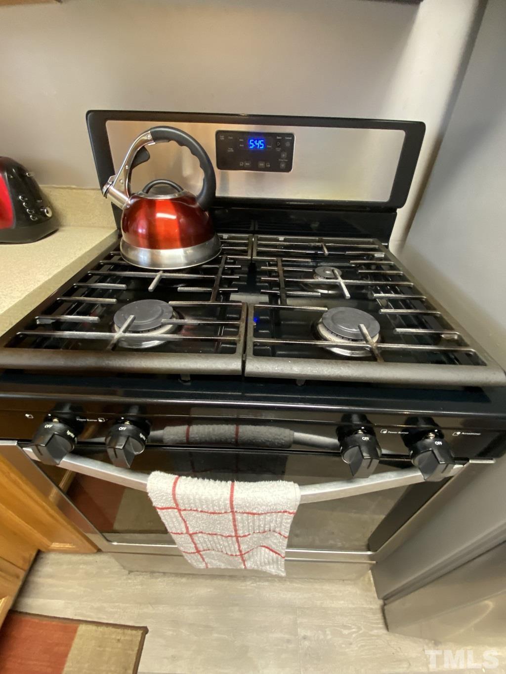 141 Jones Franklin Road, Unit H Raleigh, NC 27606 - Photo 16 of 36 a stove top oven sitting inside of a kitchen