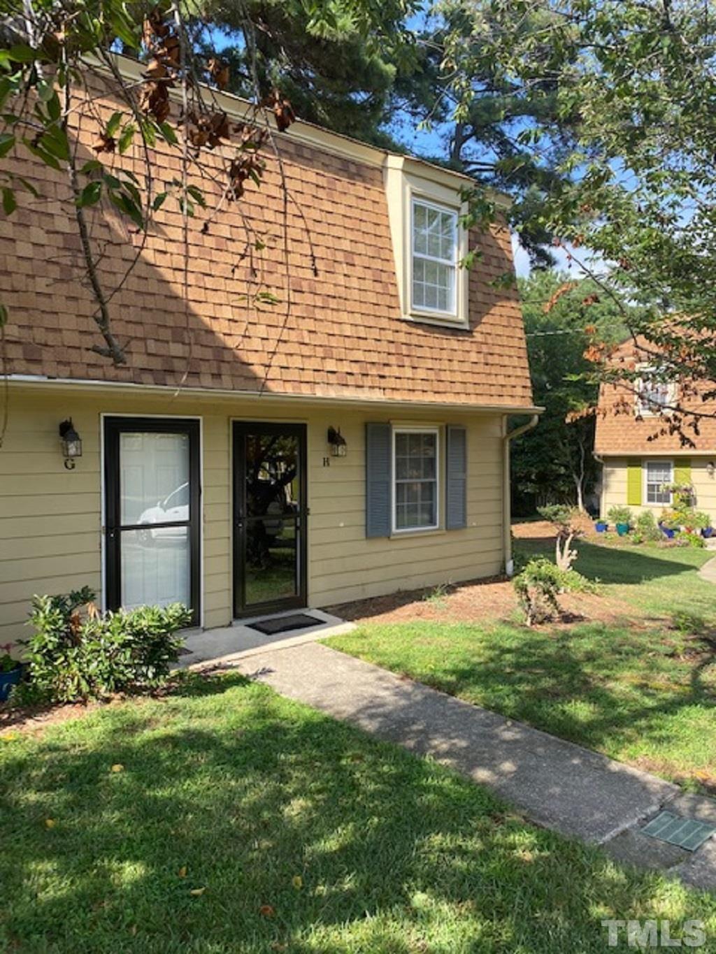 141 Jones Franklin Road, Unit H Raleigh, NC 27606 - Photo 2 of 36 front view of a house with a yard