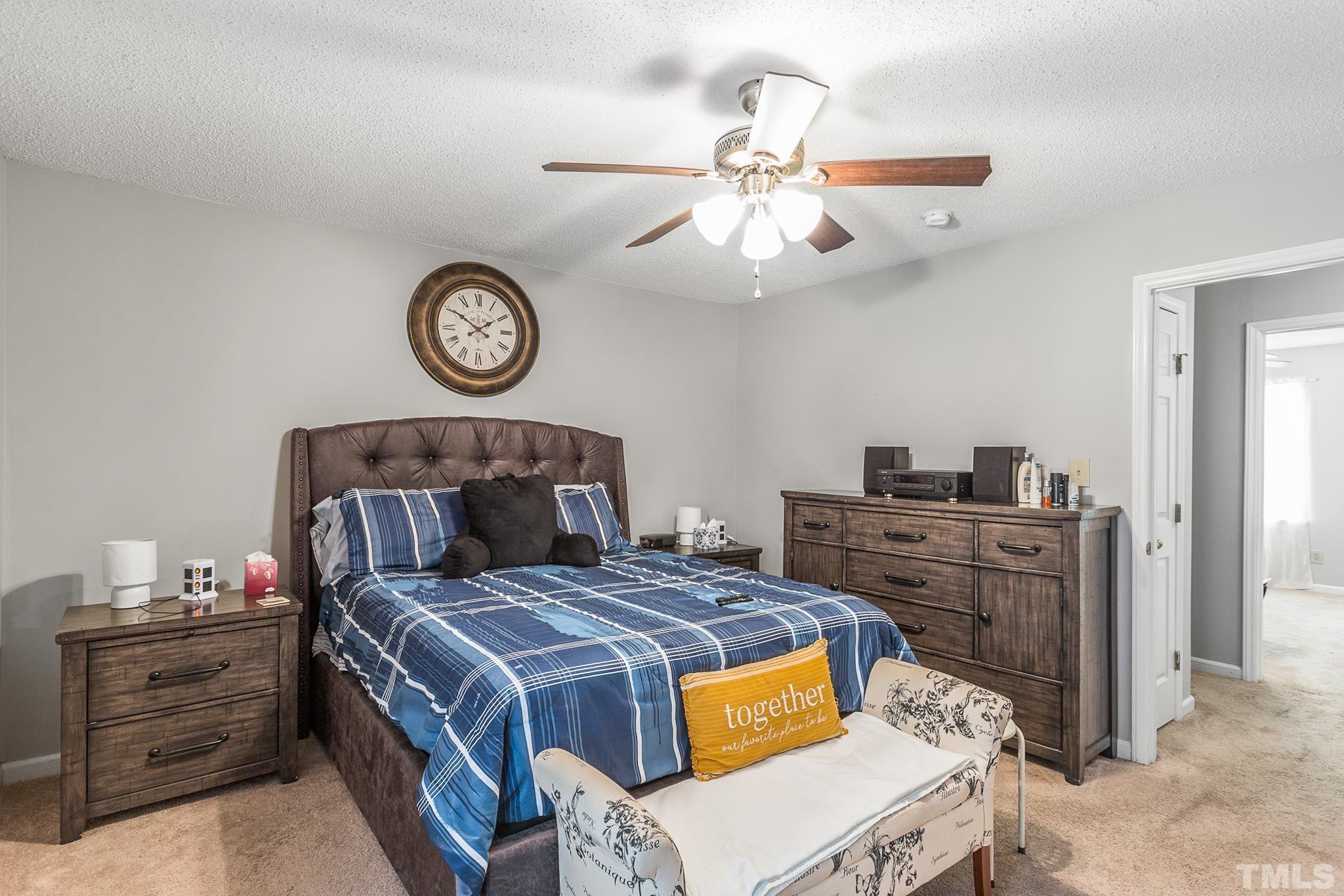 141 Jones Franklin Road, Unit H Raleigh, NC 27606 - Photo 36 of 36 a bed room with a bed and a chandelier