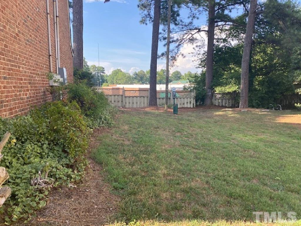 141 Jones Franklin Road, Unit H Raleigh, NC 27606 - Photo 4 of 36 a view of a yard with a tree