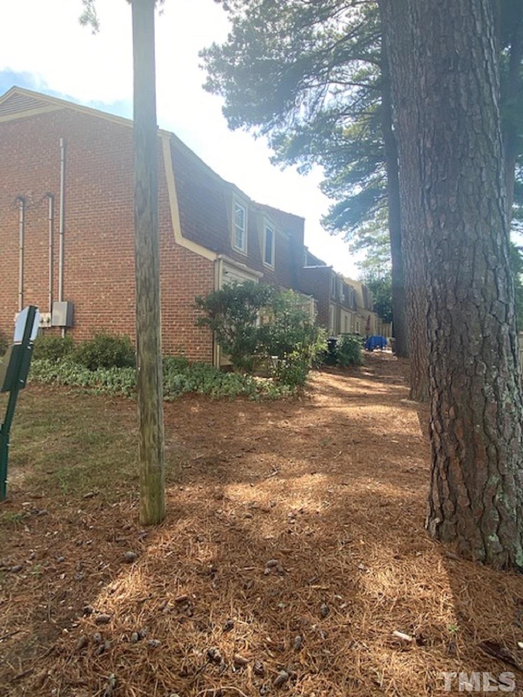 141 Jones Franklin Road, Unit H Raleigh, NC 27606 - Photo 5 of 36 a view of a yard with plants and a trees