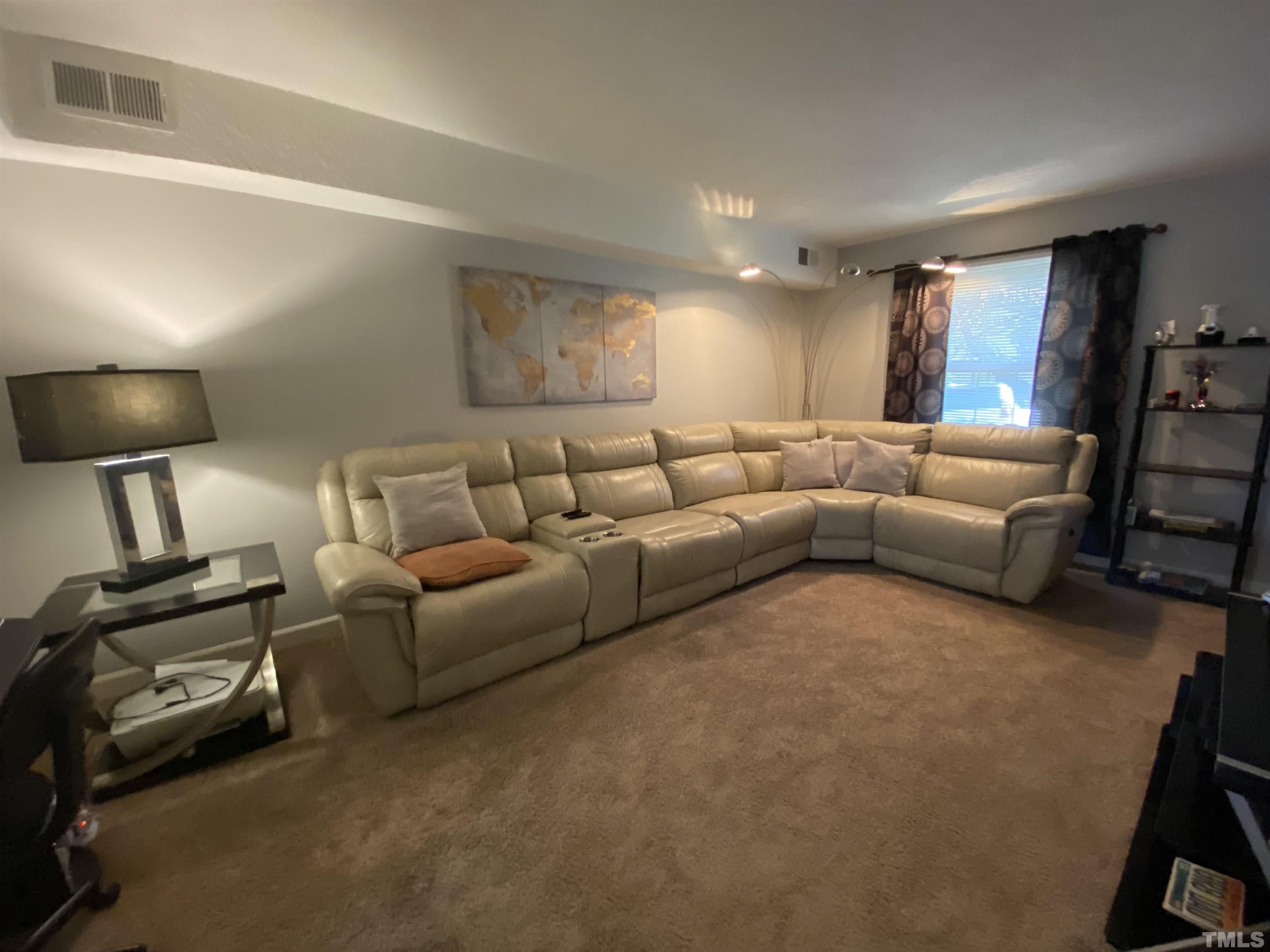 141 Jones Franklin Road, Unit H Raleigh, NC 27606 - Photo 9 of 36 a living room with furniture and a flat screen tv