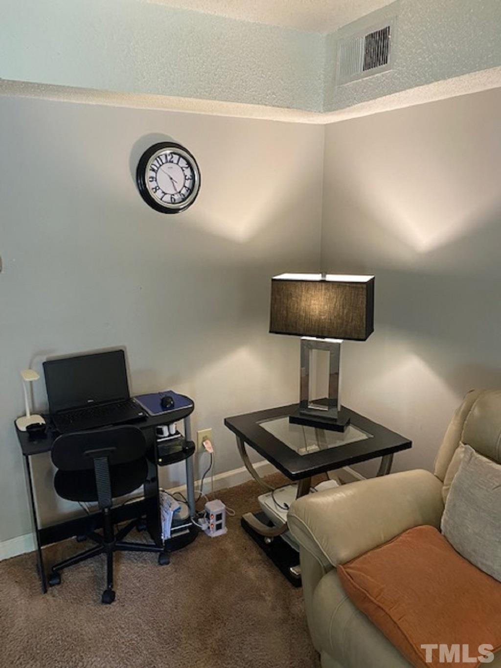 141 Jones Franklin Road, Unit H Raleigh, NC 27606 - Photo 10 of 36 a living room with a couch and a table