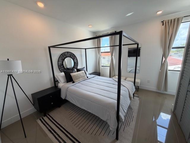 3645 Southwest 3rd Street Miami, FL 33135 - Photo 11 of 23 a bedroom with a bed a mirror and a window