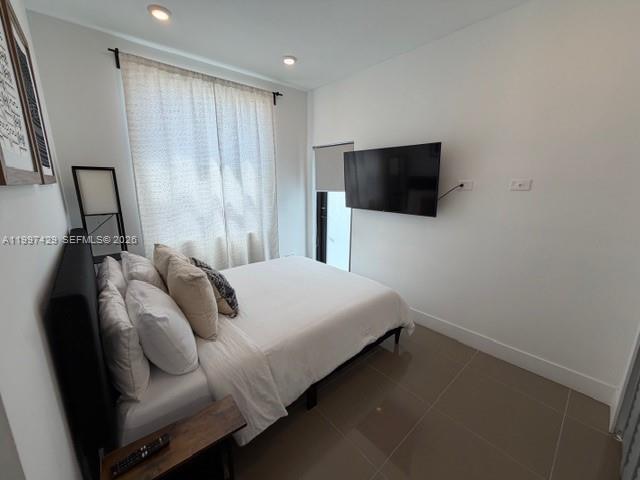 3645 Southwest 3rd Street Miami, FL 33135 - Photo 17 of 23 a bedroom with a bed and a flat screen tv