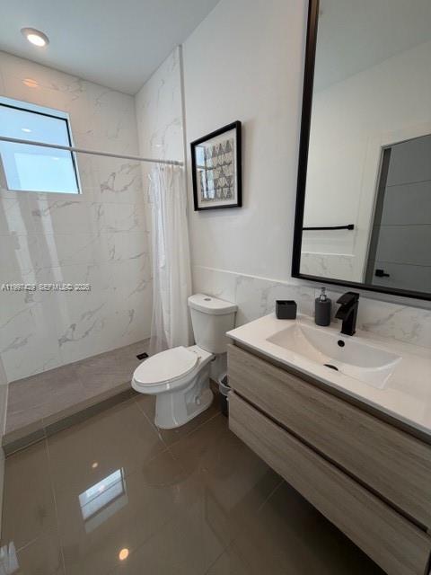 3645 Southwest 3rd Street Miami, FL 33135 - Photo 18 of 23 a bathroom with a toilet sink and mirror