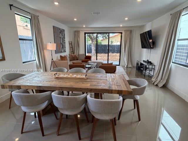 3645 Southwest 3rd Street Miami, FL 33135 - Photo 3 of 23 a view of a dining room with furniture window and wooden floor
