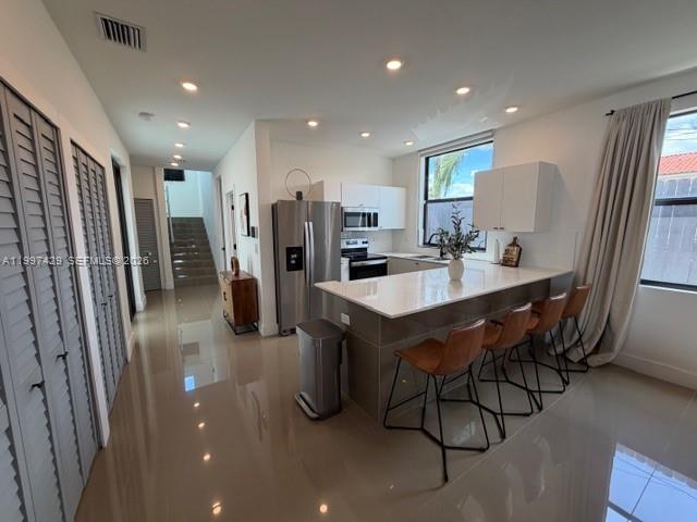 3645 Southwest 3rd Street Miami, FL 33135 - Photo 5 of 23 a kitchen with refrigerator and chairs