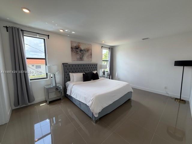 3645 Southwest 3rd Street Miami, FL 33135 - Photo 7 of 23 a bedroom with a bed and a large window