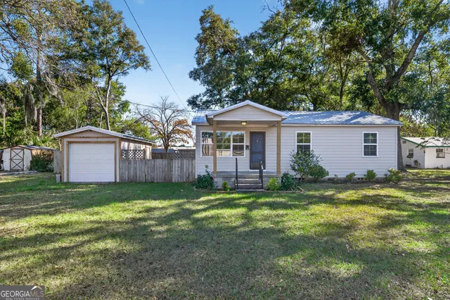 a view of a house with a yard and sitting area