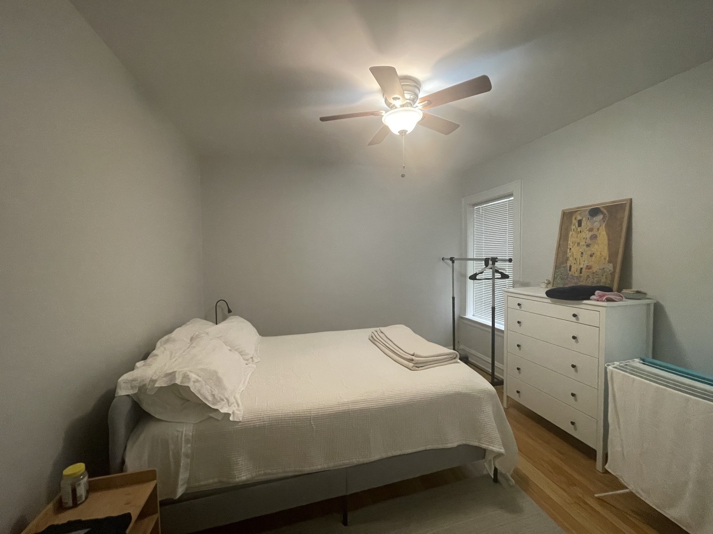 1112 Grove Street, Unit 1B Evanston, IL 60201 - Photo 11 of 14 a bedroom with a bed and a chandelier