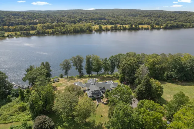 an aerial view of mountain with residential house and lake view