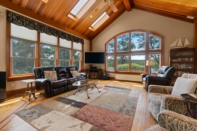 a living room with furniture a large window with outer view