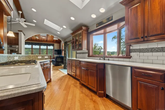 a kitchen with stainless steel appliances granite countertop a stove and a sink
