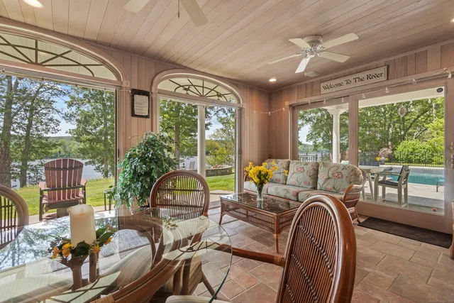 a bedroom with furniture and large windows