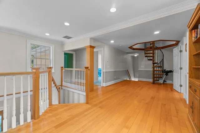 a view of a livingroom with wooden floor and entryway