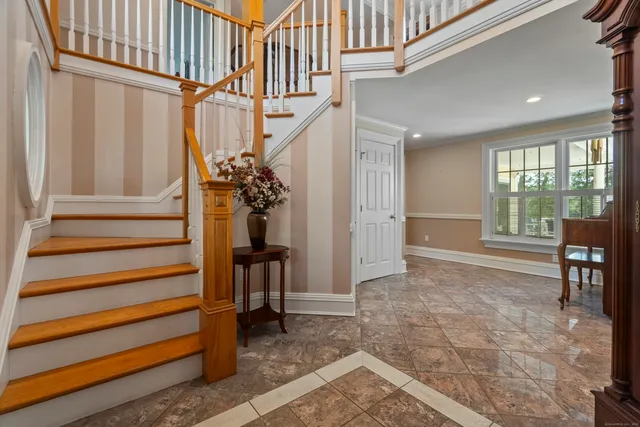 a view of entryway and hall with wooden floor