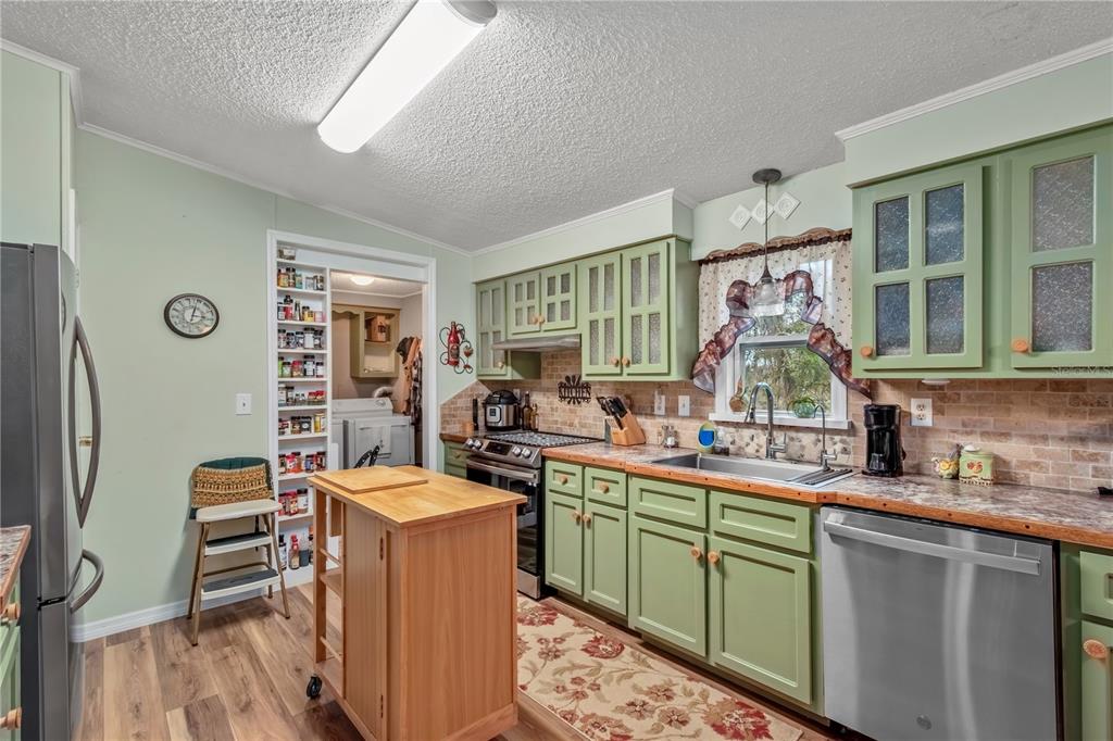 112 Magnolia Street Hawthorne, FL 32640 - Photo 11 of 41 a kitchen with a sink stove and cabinets