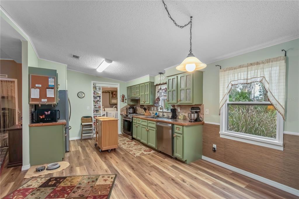 112 Magnolia Street Hawthorne, FL 32640 - Photo 13 of 41 a kitchen with stainless steel appliances granite countertop a stove and refrigerator