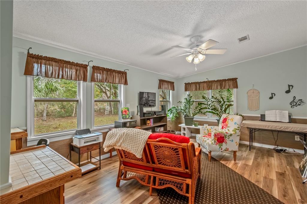 112 Magnolia Street Hawthorne, FL 32640 - Photo 15 of 41 a living room with furniture and a wooden floor