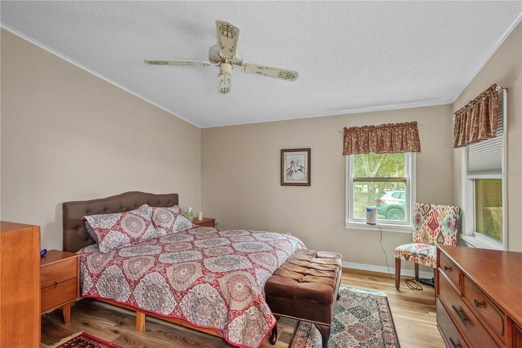 112 Magnolia Street Hawthorne, FL 32640 - Photo 18 of 41 a bedroom with a bed and wooden floor