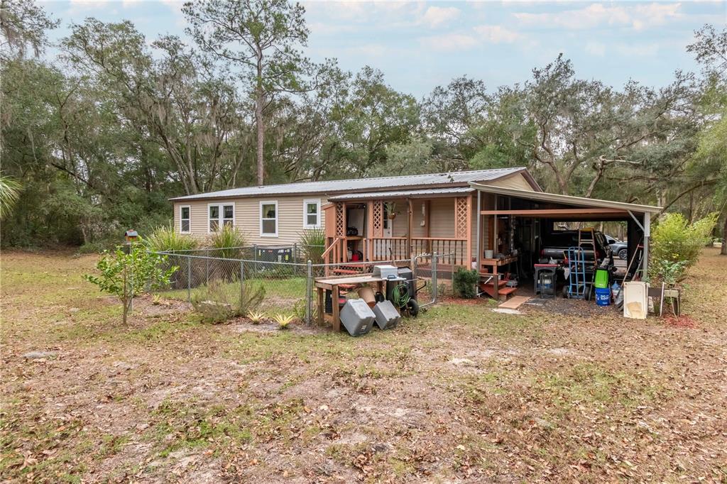 112 Magnolia Street Hawthorne, FL 32640 - Photo 33 of 41 a view of a house with backyard sitting area and garden
