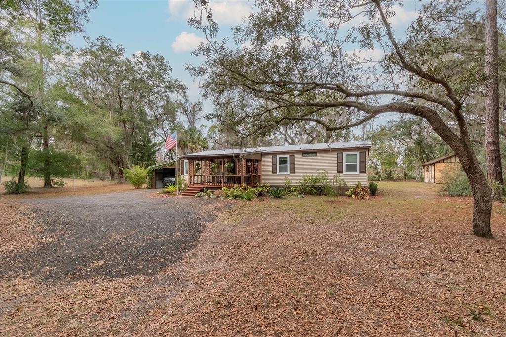 112 Magnolia Street Hawthorne, FL 32640 - Photo 38 of 41 a front view of a house with a yard and trees