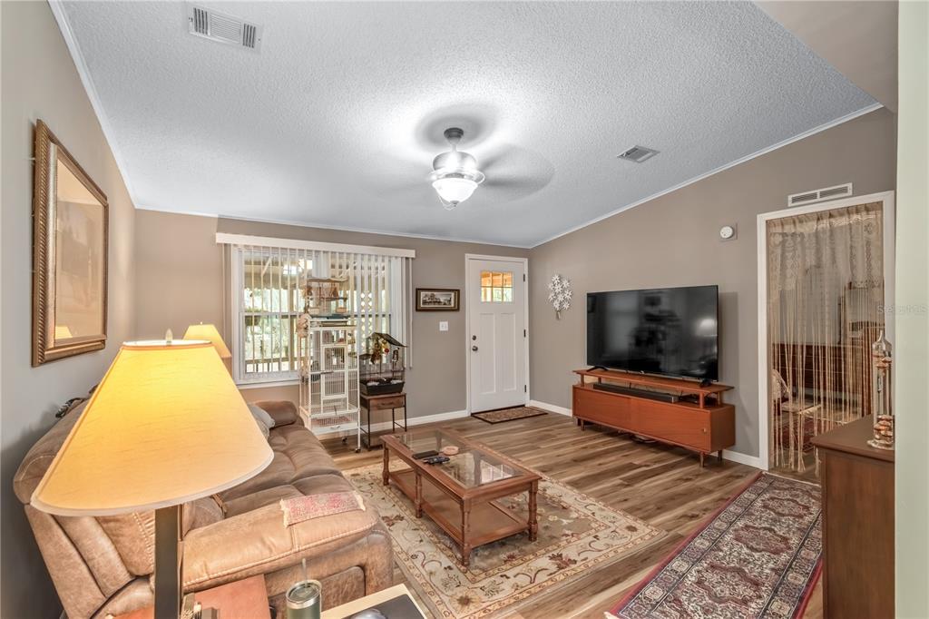 112 Magnolia Street Hawthorne, FL 32640 - Photo 9 of 41 a living room with furniture and a flat screen tv