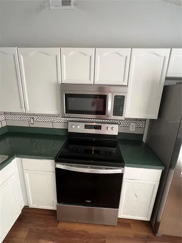 a kitchen with a stove and a microwave