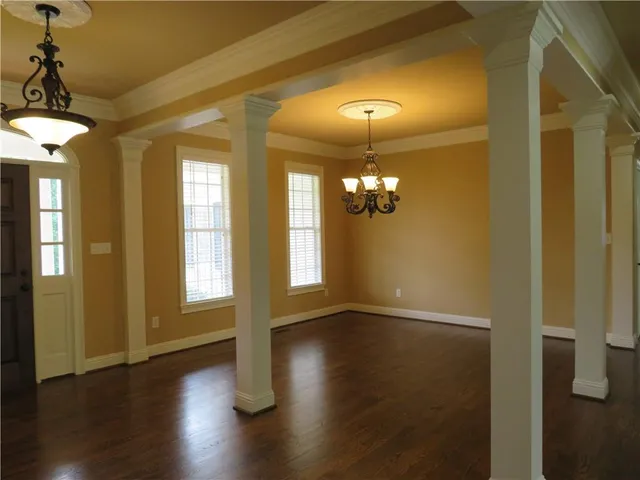 a view of livingroom with chandelier and wooden floor