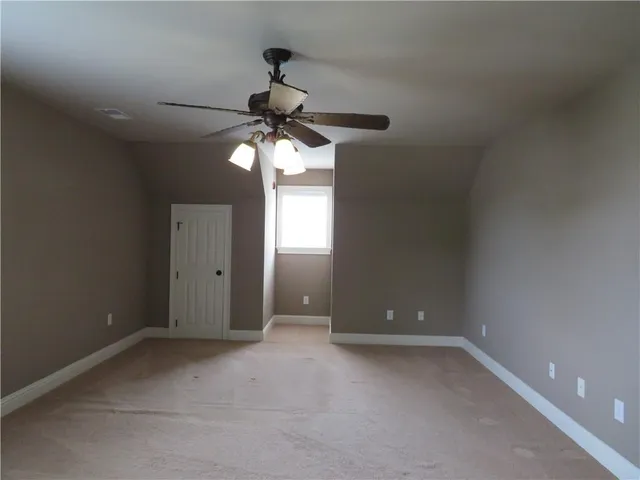 a view of a livingroom with a fireplace and a window