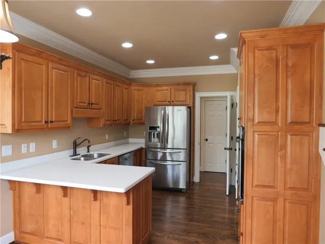 a view of a room with wooden floor and windows