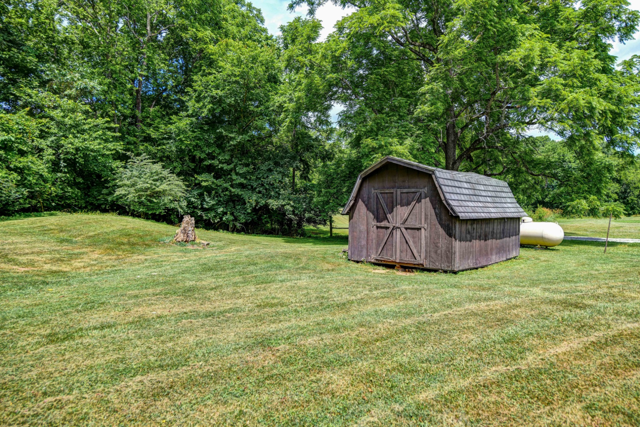 3309 Blazer Road Franklin, TN 37064 - Photo 34 of 37 a backyard of a house with wooden fence and large trees