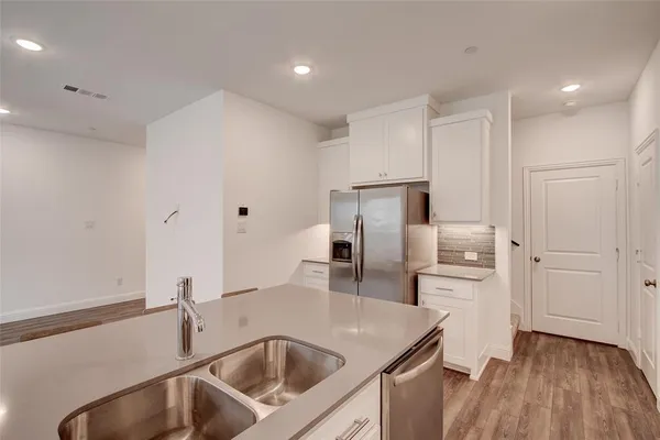 a kitchen with kitchen island a sink appliances and cabinets