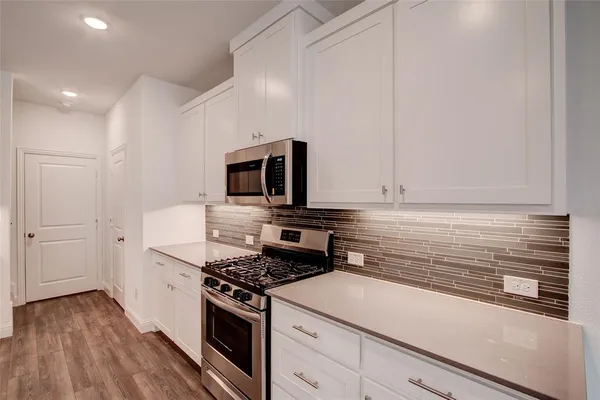 a kitchen with a stove and a microwave