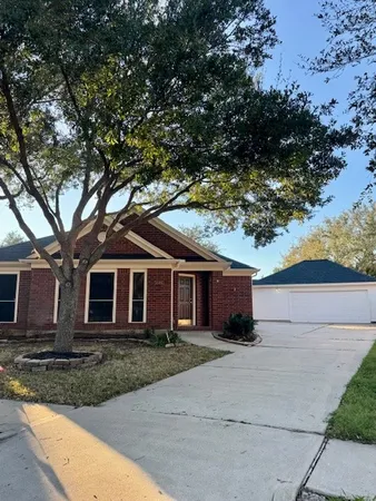 front view of a house with a tree