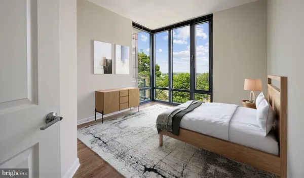 a bed sitting in a bedroom next to a window