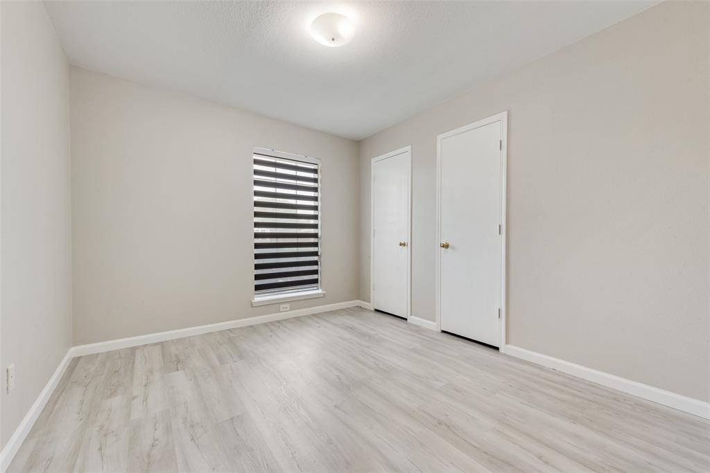 506 Pecos Path Drive Murphy, TX 75094 - Photo 13 of 19 a view of an empty room with wooden floor and a window
