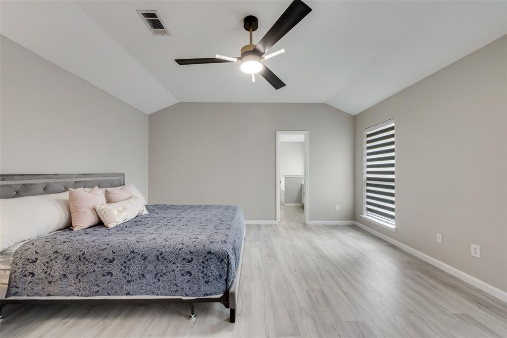 506 Pecos Path Drive Murphy, TX 75094 - Photo 16 of 19 a bedroom with a large bed and a chandelier