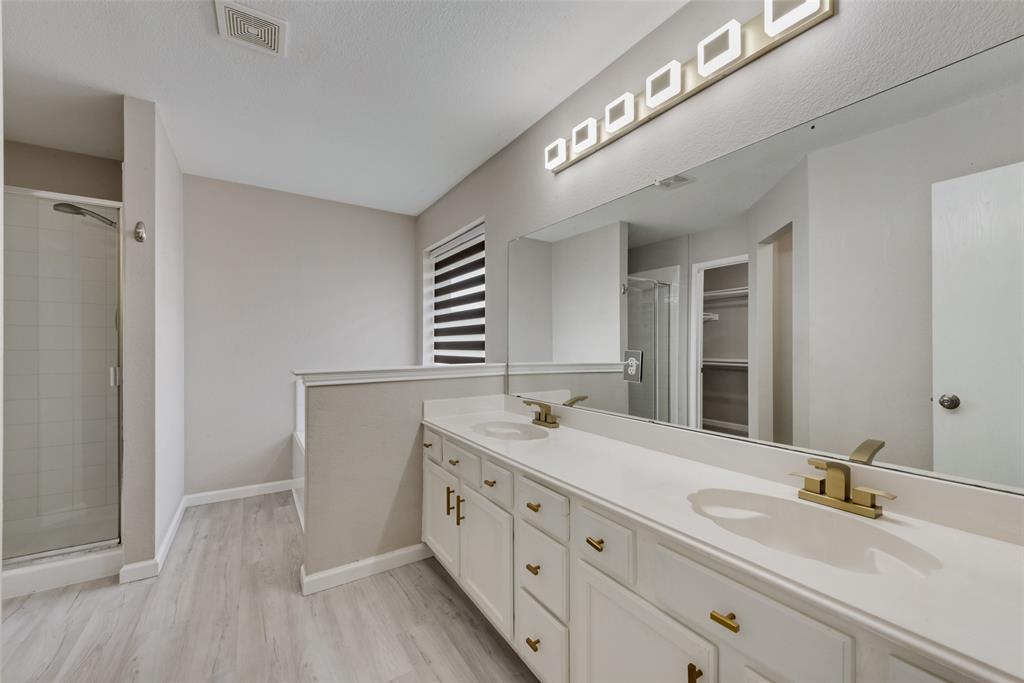 506 Pecos Path Drive Murphy, TX 75094 - Photo 17 of 19 a spacious bathroom with a double vanity sink and mirror