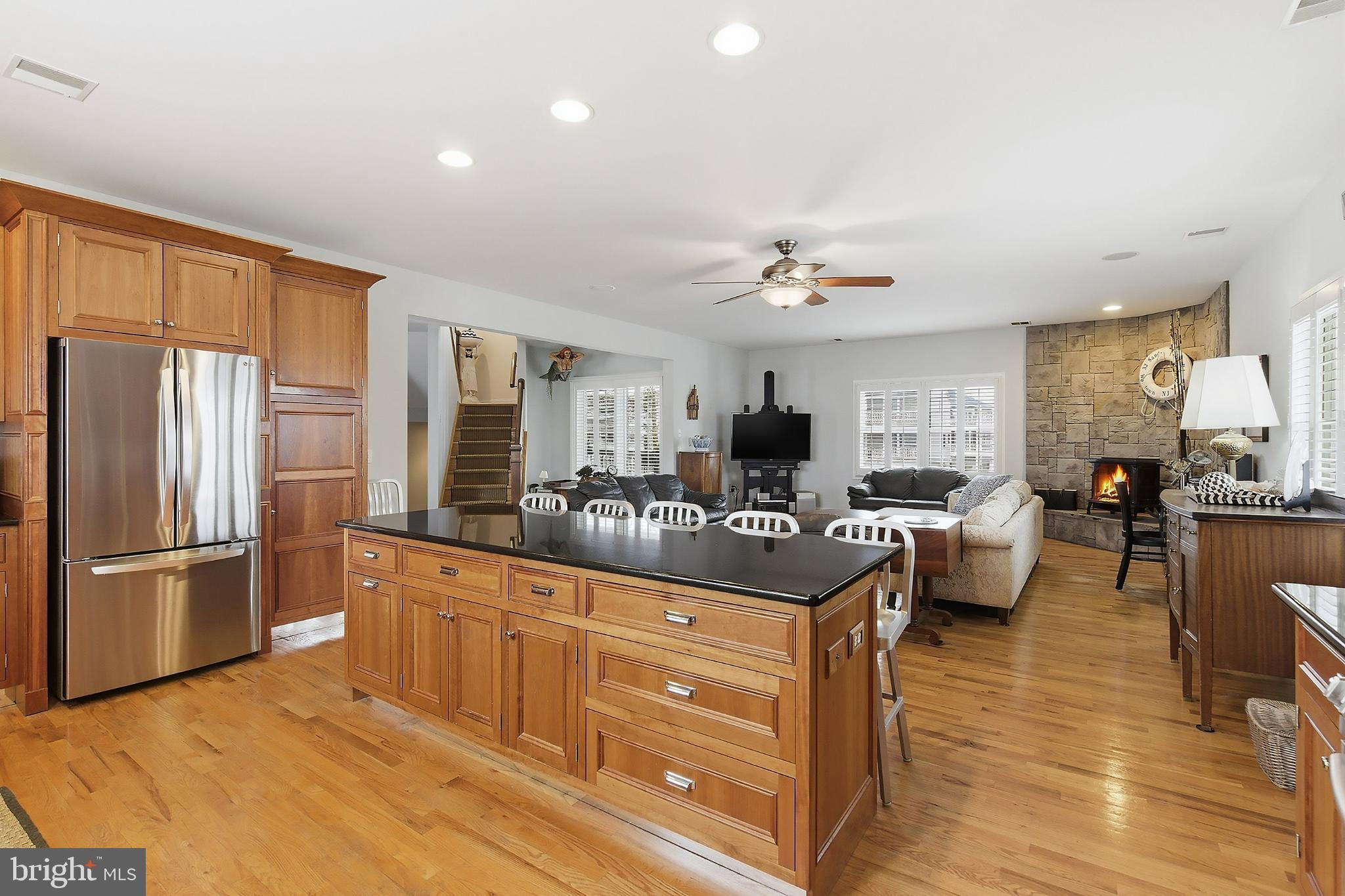 33 Sands Point Road Waretown, NJ 08758 - Photo 26 of 79 a living room with stainless steel appliances kitchen island granite countertop a refrigerator a stove a sink dishwasher and a dining table with wooden floor