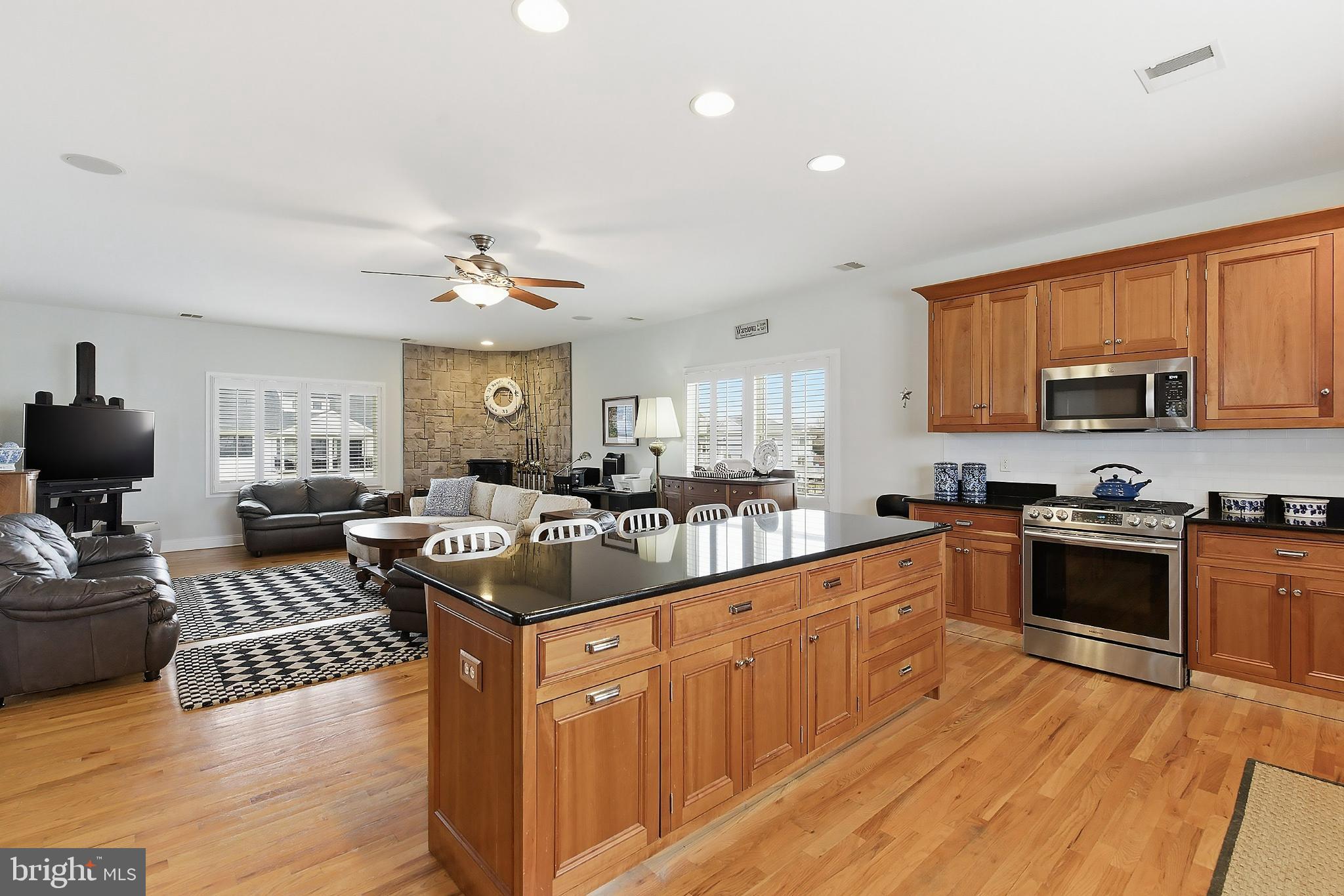 33 Sands Point Road Waretown, NJ 08758 - Photo 27 of 79 a kitchen with stainless steel appliances granite countertop wooden cabinets a sink dishwasher a stove and a refrigerator with wooden floor