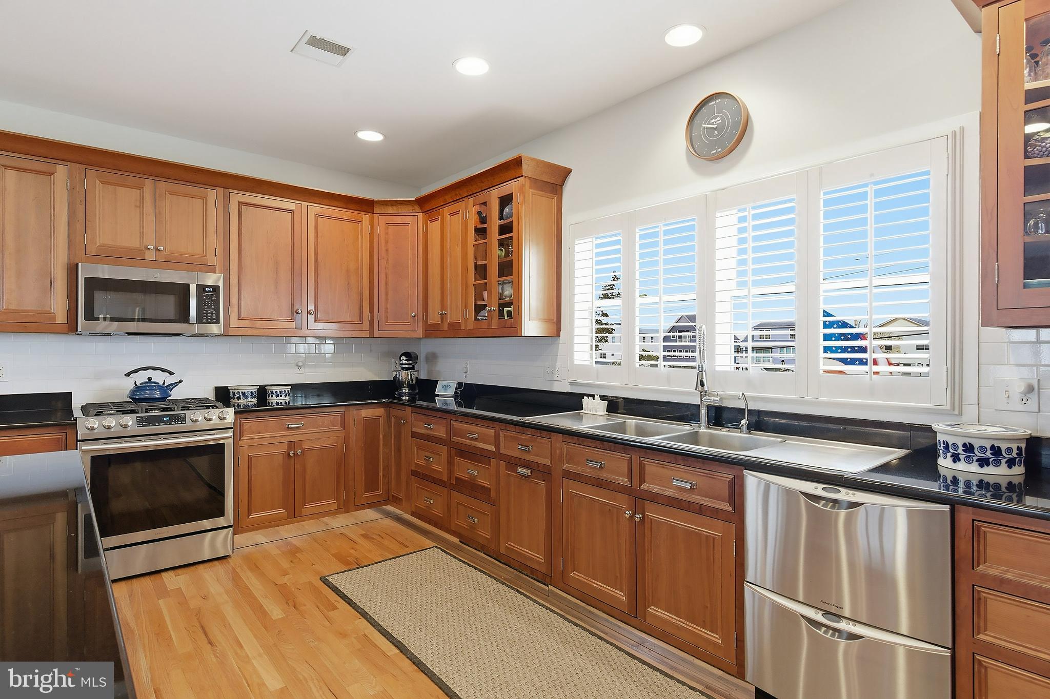 33 Sands Point Road Waretown, NJ 08758 - Photo 28 of 79 a kitchen with stainless steel appliances granite countertop wooden cabinets a sink and a stove
